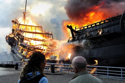 A Dutch East India Company (VOC) replica of the Prince Willem vessel burns in the historical museum harbor in Den Helder on July 30, 2009. The replica was built in 1985 at the Amels shipyard in Makkum and was 68 meters long and its mast was 54 meters. The blaze is reportedly due to an electrical incident in the ship's foyer. AFP PHOTO / MAURICE AMOUREUS            - netherlands out - belgium out - (Photo credit should read MAURICE AMOUREUS/AFP/Getty Images)